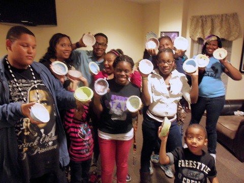 LEAP Intern Program kids painting clay ceramic bowls for Empty Bowls.