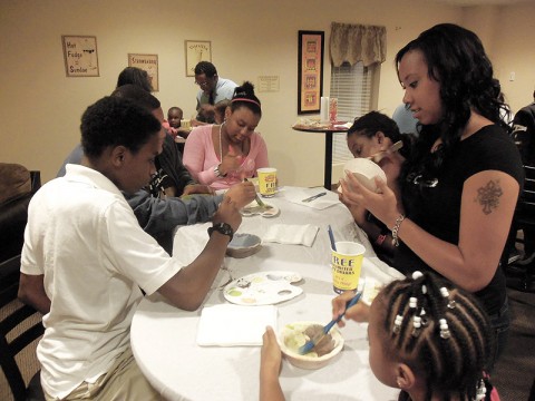 LEAP Intern Program kids painting clay ceramic bowls for Empty Bowls.