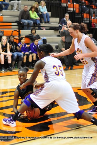 Tiasha Nicholson, floor, who scored 32 points in Clarksville High's win, fights for the ball against Lawrence County players.