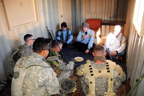 Soldiers of Company D, 1st Battalion, 502nd Infantry Regiment, 2nd Brigade Combat Team, 101st Airborne Division (Air Assault), conduct a key leadership engagement with ‘village elders’ played by other Strike Soldiers during the latest Strike Blitz at Fort Campbell, Dec. 1st. Soldiers patrolled to a village, pulled security, reacted to small arms fire and conducted a key leadership engagement to train for their upcoming deployment to Afghanistan. (U.S. Army Photo By Spc. Shawn Denham, PAO, 2nd BCT, 101st Abn. Div.)