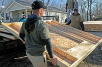 2nd Lt. Mark Patton and Pvt. 1st Class Shammah Nasheed, both with 2nd Battalion, 502nd Infantry Regiment, 2nd Brigade Combat Team, 101st Airborne Division (Air Assault), carry pre-made walls to be installed at a house under construction in Hopkinsville, KY, Dec. 10th. Strike Force Soldiers volunteered with Habitat for Humanity to help construct a home for a family in need. (U.S. Army Photo By Spc. Shawn Denham, PAO, 2nd BCT, 101st Abn. Div.)