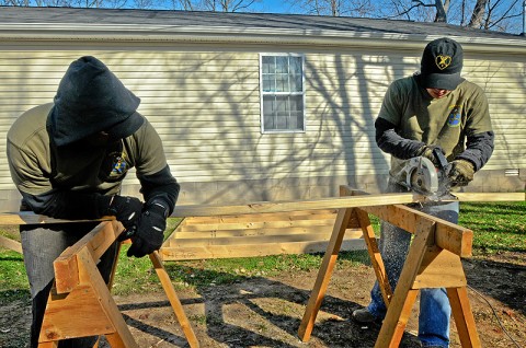 Pvt 1st Class Shammah Nasheed and Sgt. Justin Higgason, Soldiers with Company B, 2nd Battalion, 502nd Infantry Regiment, 2nd Brigade Combat Team, 101st Airborne Division (Air Assault), cut wood braces for use while installing walls at a Habitat For Humanity project in Hopkinsville, KY, Dec. 10th. The Saturday prior, Strike Force Soldiers assisted with foundation installation and floor bracing. (U.S. Army Photo By Spc. Shawn Denham, PAO, 2nd BCT, 101st Abn. Div.)