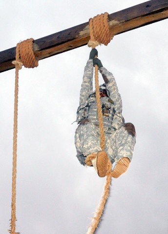 Sgt. David Dixon, with Company B, 526th Brigade Support Battalion, 2nd Brigade Combat Team, 101st Airborne Division (Air Assault), climbs to the top of the rope during the latest Strike Iron Competition held at Fort Campbell, Dec. 15th. The original competition had the rope event towards the end, but the new design has Soldiers attempting it first to prevent muscle failure. (U.S. Army Photo By Spc. Shawn Denham, PAO, 2nd BCT, 101st Abn. Div.)