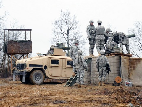 Soldiers from 1st Squadron, 32nd Cavalry, 1st Brigade Combat Team, 101st Airborne Division, load a Tube-Launched, Optically-Tracked, Wire Command Data Link Missile into a tube mounted on a barrier Dec. 6th in Fort Knox, KY. (Photo by Sgt. Jon Heinrich)