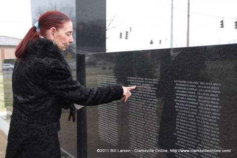 Malinda Parris looks at her husband's name on the Gander Crash Memorial