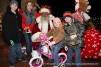 A young girl sitting on the bicycle she was just given at the 2011 Christmas on the Cumberland