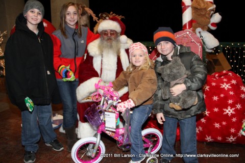 A young girl sitting on the bicycle she was just given at the 2011 Christmas on the Cumberland