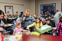 Thea Wendel, wife of Spc. Jason Wendel of Company B, 1st Battalion, 502nd Infantry Regiment, 2nd Brigade Combat Team, 101st Airborne Division (Air Assault) and their children Mason, Audrey and Christian receive presents for Christmas donated by the Occupational Therapy Group from Milligan College at Strike Academy Dec. 15th. The Milligan College campus and its surrounding communities in eastern Tennessee provided the gifts for 89 little Bulldogs. (U.S. Army photo by Sgt. Joe Padula, 2nd BCT PAO, 101st Abn. Div.)