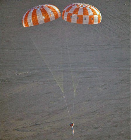 A test article that mimics the Orion spacecraft is seen under parachutes Tuesday as NASA engineers conducted a drop test above Yuma, AZ. The Orion team was examining how the spacecraft would land under only two parachutes, instead of the normal three. 