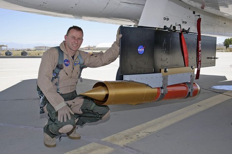 NASA research pilot Jim Less checks out the CCIE experimental jet engine inlet mounted underneath NASA's F-15B prior to a test flight. (NASA / Tony Landis)