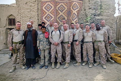 Marines with Border Advisor Team 1, currently attached in support of 1st Light Armored Reconnaissance Battalion, and Afghan Border Police members pause for a photo after a day of classes. Major James M. Moore of Lilburn, GA, the Border Advisor Team leader, said the progress the ABP has shown in the six weeks his team has been in Afghanistan is great. He added he gives credit to his team of Marines and sailors who work tirelessly to keep the ABP’s skills sharp. (Photo by Cpl. Marco Mancha)