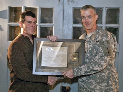 Chief Warrant Officer 3 Richard Nielsen (left) is presented the Army Aviation Broken Wing certificate by Col. John Thompson, 160th Special Operations Aviation Regiment (Airborne) commander.  Nielson and two others received the award from the U.S. Army Safety Center for his actions during an in-flight emergency. (Photo by 160th Special Operations Aviation Regiment (A) Public Affairs)