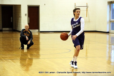 Jessy Ward at a Clarksville High Lady Wildcats basketball practice with coach Brian Rush watching in the background.