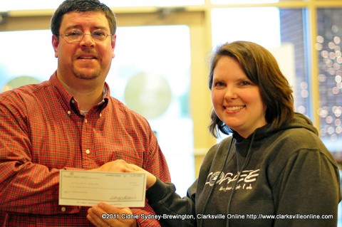 Sango Lasaters manager Megan Ryle presents Lasaters Christmas Giveaway winner Michael Clark with the prize of $1000 in the form of a check Friday, December 23rd. Sango Lasaters manager Megan Ryle presents Lasaters Christmas Giveaway winner Michael Clark with the prize of $1000 in the form of a check Friday, December 23rd.