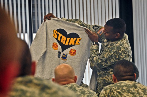 Command Sgt. Maj. Alonzo Smith, command sergeant major, 2nd Brigade Combat Team, 101 Airborne Division (Air Assault) holds up a Strike sweat shirt intended for the 2nd BCT Wounded Warriors during their visit back to Strike, Jan. 12th. The wounded warriors are currently assigned to Fort Campbell’s Warrior Transition Battalion and still carry a strong bond with the 2nd BCT. (U.S. Army photo by Sgt. Joe Padula, 2nd BCT PAO, 101st Abn. Div.)