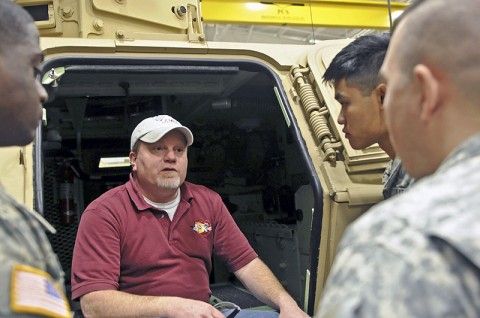 Allen Gentry, a training instructor with DRS Technologies based out of St. Louis, quizzes mechanics with the 1st Brigade Combat Team on the M1200 Armor Knight here Jan. 10th at the brigade motor pool. (Photo by Sgt. Richard Daniels Jr.)