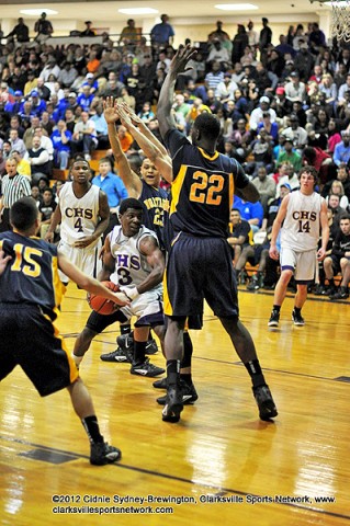 Clarksville's Daijon Williams trapped in a Northeast triple team. In a great upset for Northeast, the Clarksville High Wildcats win it 69-60.