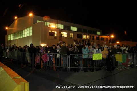 Families wait outside in the early morning cold for their loved ones flight to touch down.  