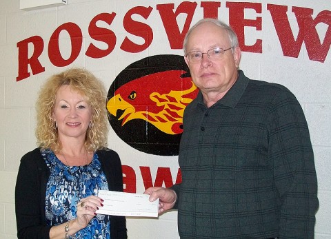 Planters Bank Branch Manager and Assistant Vice President Stacey Wenzler presents a check to Rossview Middle school's Assistant Principal Jimmy Crawford.