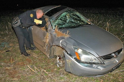 Clarksville Police Officer Tom Johnson investigates the crash scene. (Photo by CPD - Jim Knoll)