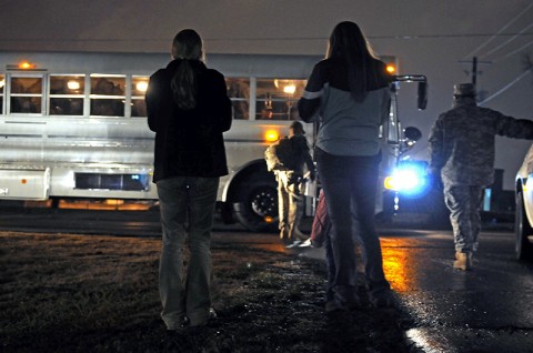 Families and friends watch the soldiers of the Headquarters and Headquarters Detachment, 716th Military Police Battalion, 101st Sustainment Brigade, as they prepare to depart Fort Campbell for a deployment to Afghanistan. (Photo by Spc. Michael Vanpool)