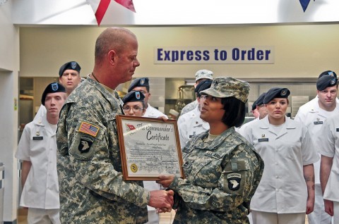 Command Sgt. Maj. Mark Herndon, Fort Campbell’s garrison command sergeant major, presents the Commander’s Certificate for best dining facility during the Thanksgiving holiday to Sgt. 1st Class Raquel Mendoza, a platoon sergeant with Company E, 1st Battalion, 502nd Infantry Regiment, 2nd Brigade Combat Team, 101st Airborne Division (Air Assault), at the Strike Dining Facility, Jan. 24th. (U.S. Army photo by Sgt. Joe Padula, 2nd BCT PAO, 101st Abn. Div.)