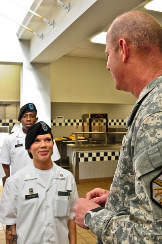 Command Sgt. Maj. Mark Herndon, Fort Campbell’s garrison command sergeant major, thanks Spc. June Tompkins, a Soldier chef with Company F, 1st Battalion, 502nd Infantry Regiment, 2nd Brigade Combat Team, 101st Airborne Division (Air Assault) during the award ceremony for the Commander’s Certificate held at the Strike Dining Facility, Jan. 24th. The Commander’s Certificate is awarded for best dining facility during the Thanksgiving holiday and the Strike Soldier chefs worked hard and for many hours to ensure the Soldiers and Family Members enjoyed their holiday feast. (U.S. Army photo by Sgt. Joe Padula, 2nd BCT PAO, 101st Abn. Div.)