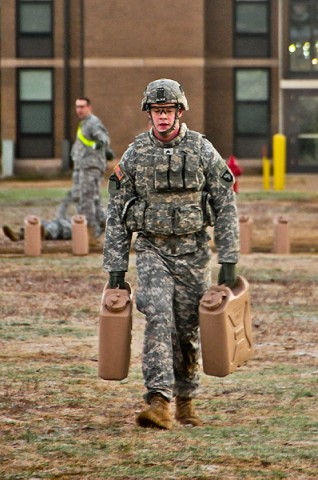 Sgt. Corey Allen, a fire support specialist with Headquarters and Headquarters Company, 2nd Brigade Combat Team, 101st Airborne Division (Air Assault), carries fully loaded water jugs for 300-meters during a combat focused physical training event. (U.S. Army photo by Sgt. Joe Padula, 2nd BCT PAO, 101st Abn. Div.)