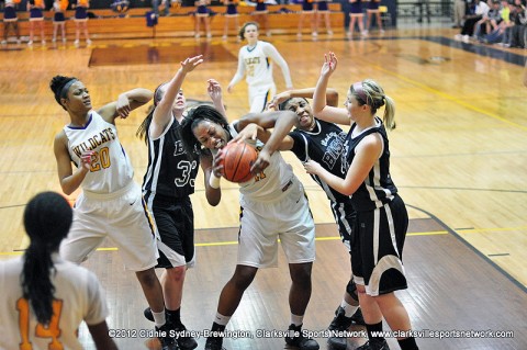 Bashaara Graves goes up against a Station Camp triple team. In the second round of the Region 5-AAA Tournament, Clarksville High School breeze passed Station Camp 66-27.