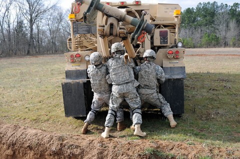 Pfc. Douglas Rosser, a welder, and Spc. Justin Lord, a recovery operator, both with Company B, 426th Brigade Support Battalion, 1st Brigade Combat Team, 101st Airborne Division, hook up an incapacitated vehicle here at the ranges Jan. 31st. (Photo by Sgt. Richard Daniels Jr.)