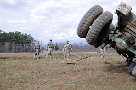 Soldiers of Company B, 426th Brigade Support Battalion, 1st Brigade Combat Team, 101st Airborne Division, watch as their wrecker pulls the incapacitated vehicle upright here at the ranges Jan. 31st. (Photo by Sgt. Richard Daniels Jr.)