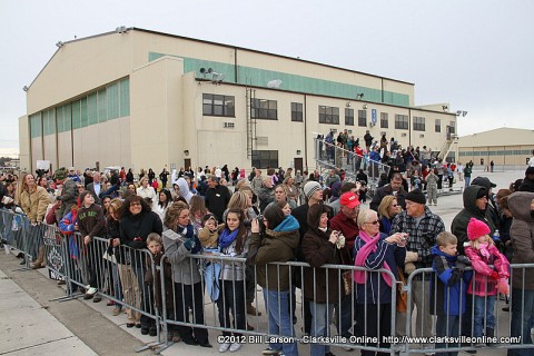 Families wait for the aircraft bringing their loved ones home to land