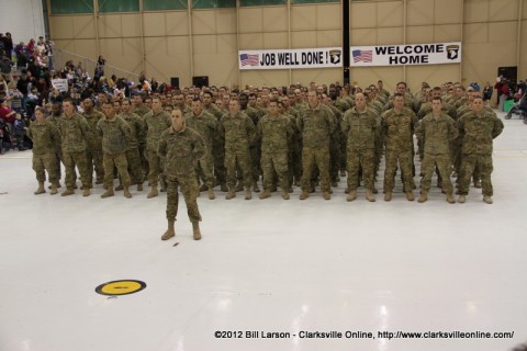 The returning soldiers stand proudly before their loved ones and friends