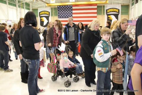 Families head outside to see the airplane bearing their loved ones arrive