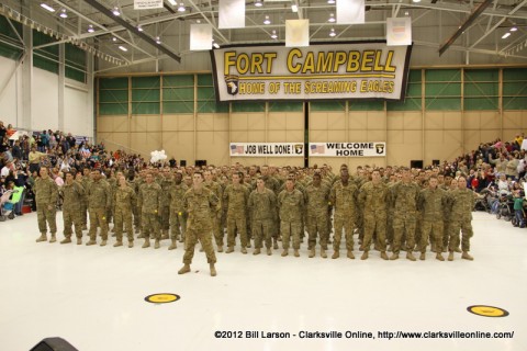 The returning soldiers stand proudly before their families and loved ones