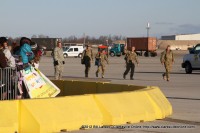 A soldier waves to his family