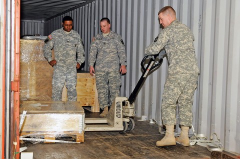 Spc. Eric Dorough, who works in storage at the 101st Sustainment Brigade Supply Support Activity, with the 305th Quartermaster Company, 129th Combat Sustainment Support Battalion, 101st Sust. Bde., pulls pieces of the new lift systems for the SSA. The two new automated units will expand the space for storage and cut down on time spent looking for parts and supplies. (Photo by Spc. Michael Vanpool)