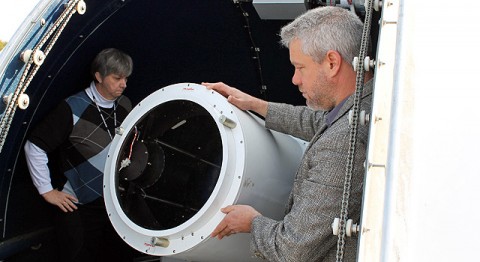 NASA's Jan McGarry (left) and Stephen Merkowitz stand next to the Next-Generation Satellite Laser Ranging (NGSLR) system, one of the ground stations that makes up the quadrangle of instruments known as the Space Geodesy project, as it peeks through the station's open dome. The NGSLR laser ranges to Earth-orbiting satellites and to NASA's Lunar Reconnaissance Orbiter. McGarry leads the development of the NGSLR and Merkowitz is the project manager for the Space Geodesy project. (Image Credit: NASA/GSFC/Elizabeth Zubritsky)