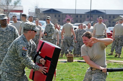 Pfc. Jenna A. Knapp of the 194th Miltary Police Company, 716th Military Police Battalion, 101st Sustainment Brigade, fends off an attacker while being temporarily blinded by pepper spray. The training was the final part of the battalion’s Law Enforcement Training Seminar. (Courtesy Photo)