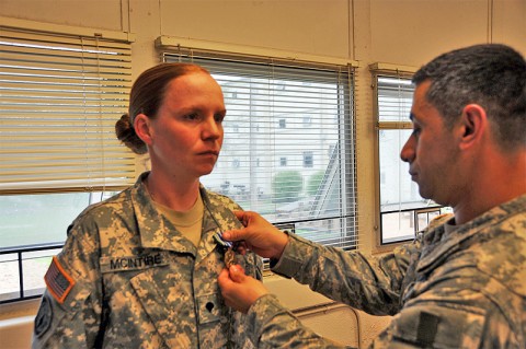 Spc. Katherine McIntire receives an Impact Army Achievement Medal for her actions in saving the life of a four-year-old boy who was choking. McIntire is assigned to the 194th Military Police Company, 716th Military Police Battalion, 101st Sustainment Brigade (photo by 1st Lt. Janet Brown, Unit Public Affairs Representative, 716th Military Police Bn., 101st Sut. Bde.)