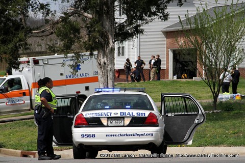 The Clarksville Police officers who entered the home on Quicksilver Court are debriefed in the background