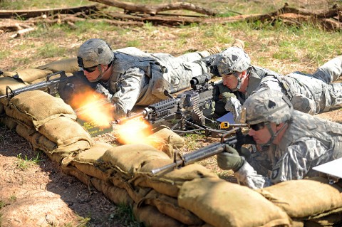 U.S. Army 1st Lt. Thomas A. Reece, a platoon leader for Company E, 2nd Battalion, 506th Infantry Regiment, 4th Brigade Combat Team, 101st Airborne Division, engages a simulated enemy opposition force with the M240B Medium Machine Gun during the Reconnaissance Lane portion of the Expert Infantryman Badge testing, March 5th, 2012 at Fort Campbell, KY. (Photo by Staff Sgt. Todd Christopherson)