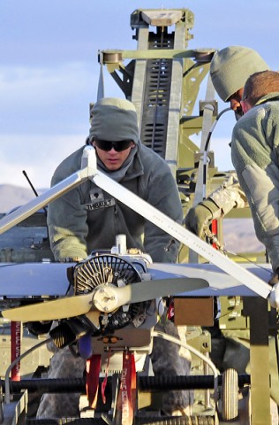 Spc. David Thibault, F Troop, 2nd Squadron, 17th Cavalry Regiment, 101st Combat Aviation Brigade, unmanned aerial system maintainer, loads a UAS on to the launching machine during pre-flight operations, Feb. 17th, 2012, at the National Training Center, Fort Irwin, CA.