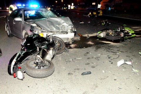 A Pontiac Grand Am turns in front of three motorcycles on Fort Campbell Boulevard Wednesday night. All three motorcycles collided with the car.