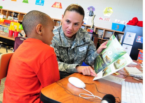 U.S. Army 1st Lt. Monica M. Baker, a human resource officer from Headquarters and Headquarters Battery, 4th Battalion, 320th Field Artillery Regiment, 4th Brigade Combat Team, 101st Airborne Division, and native of Tampa, Fla., reads with a kindergartener, April 24, 2012, during her visit to West Creek Elementary School in Clarksville, Tenn. (Photo by Sgt. Kimberly Menzies)