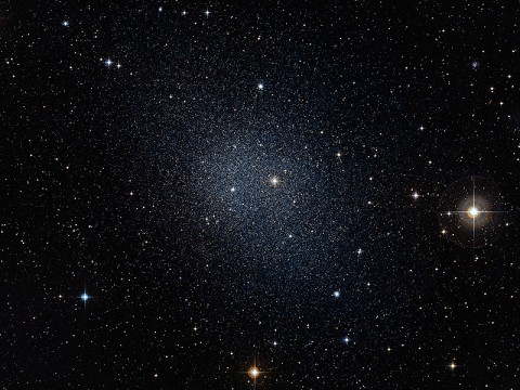 This dwarf spheroidal galaxy in the constellation Fornax is a satellite of our Milky Way and is one of 10 used in Fermi's dark matter search. The motions of the galaxy's stars indicate that it is embedded in a massive halo of matter that cannot be seen. (Credit: ESO/Digital Sky Survey 2)