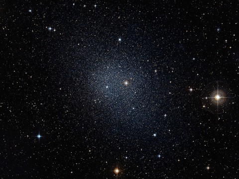 This dwarf spheroidal galaxy in the constellation Fornax is a satellite of our Milky Way and is one of 10 used in Fermi's dark matter search. The motions of the galaxy's stars indicate that it is embedded in a massive halo of matter that cannot be seen. (Credit: ESO/Digital Sky Survey 2) This dwarf spheroidal galaxy in the constellation Fornax is a satellite of our Milky Way and is one of 10 used in Fermi's dark matter search. The motions of the galaxy's stars indicate that it is embedded in a massive halo of matter that cannot be seen. (Credit: ESO/Digital Sky Survey 2)
