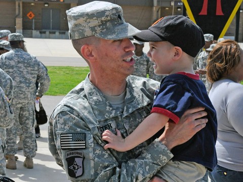 Spc. Teale Foster, with the 101st Human Resources Company, Special Troops Battalion, 101st Sustainment Brigade, bonds with his son during a welcome home ceremony, April 8th. The 101st HR Company returned to Fort Campbell Easter Sunday after a nine-month deployment to Kuwait. (Photo by Spc. Michael Vanpool)