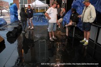 The crew of the Public Square Stage wait to see if the wet weather was going to clear up enough to resume the entertainment