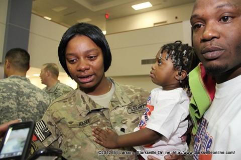 Specialist Kent cries tears of joy  as she holds her daughter for the first time in a year